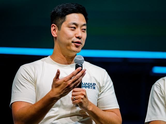 Tim Yu speaking on stage